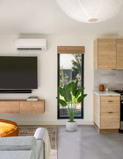 A modern living room with a tv mounted on the wall.