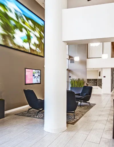 A modern lobby with a large picture on the wall.